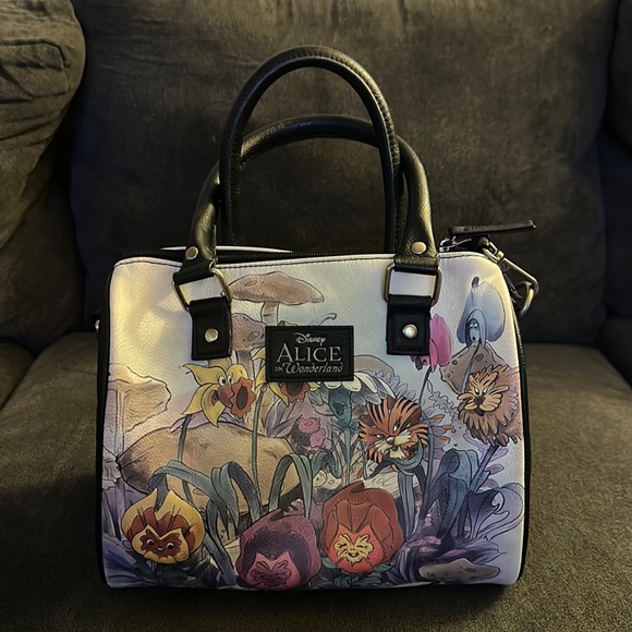 Purse.Alice in wonderland design. Slightly used. Zipper. Handheld for shoulder. - Picture 1 of 3